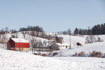 Amish Farm and Homestead in the Winter Nestled in a Small Snowy Valley