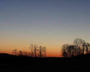 Fototapeta na wymiar Cloudless Sunset with Silhouettes of Trees | Dusk in Ohio's Amish Country