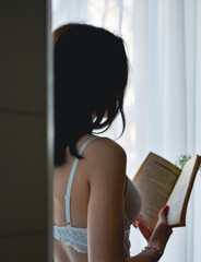 woman reading a book in the bedroom