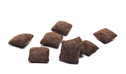Cereal flakes in form of pillows, with vanilla flavor, pile isolated on white