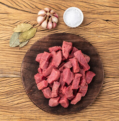 Chopped topside meat over wooden board with seasonings