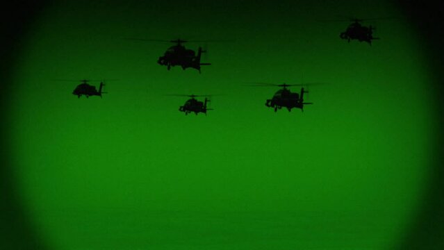 Apache AH-64 helicopters fly at night, night vision infrared