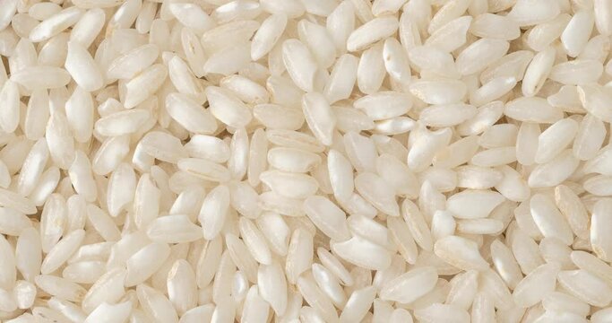 Closeup, top view of raw carnaroli risotto rice. Food backdrop