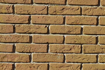 Close up Dutch red brick wall in the sun. Deep, rough joints. February, Netherlands.