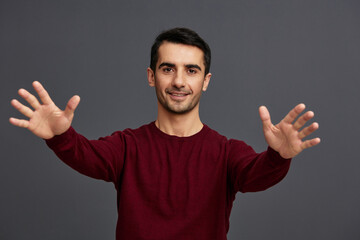 handsome man posing smile gesture hands red sweater cropped view