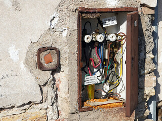 Fototapeta na wymiar Detail of an open cabinet with an old electricity distribution.