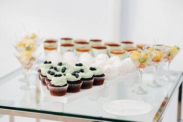 wedding cake on a table, fruit in the glass.