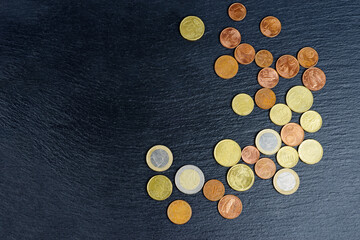 Euro coins on black background.