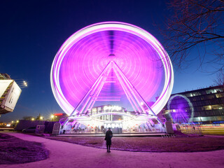 Woman watching fast spinning wheel in park © Jacek Dylag