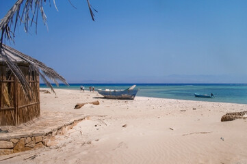 old wooden fishing boats resting on the beach of the bay blue lagoon in egypt