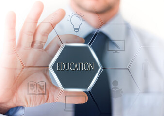 Business hand holding an hexagonal digital interface with text ”education” inside.