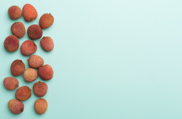 Lychee fruit on color background. Top view, flat lay
