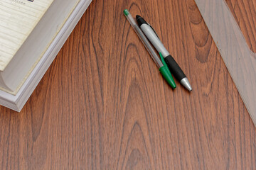 Measuring instruments and pens on a desk. Wooden desk.
