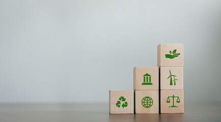 ESG Concepts on Environment, Society and Governance Revolving Sustainable Organization Development Wooden block with environmental ESG icon on gray background. copy space - Powered by Adobe