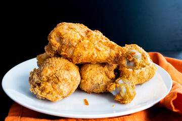 Air Fryer Southern Fried Chicken Chicken Drumsticks: Side view of a plate of breaded and air fried...