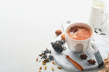 Masala tea. Masala chai spiced tea with milk and spices on light grey background. Traditional...