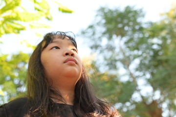 Fototapeta premium Little girl are absent-minded and looking out