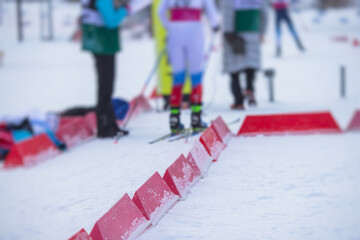 Alpine skiing race slalom competition, athletes ready to start ski competitions on a piste slope,...