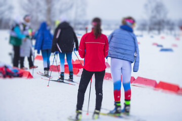 Obraz premium Alpine skiing race slalom competition, athletes ready to start ski competitions on a piste slope, nordic ski skier on the track in winter, giant slalom, winter sport and acitivities concept
