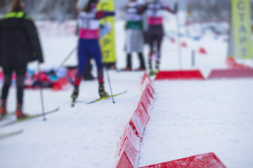 Alpine skiing race slalom competition, athletes ready to start ski competitions on a piste slope, nordic ski skier on the track in winter, giant slalom, winter sport and acitivities concept - obrazy, fototapety, plakaty