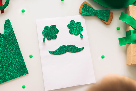 Children's Card Made Of Paper Green Shiny Clover For Patrick's Day In Isolation.