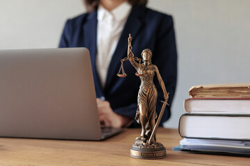a female lawyer conducts an online consultation from a laptop via video link for a client. work in...