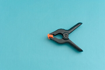 Clamp to hold photographic backgrounds. Caliper isolated on blue background.