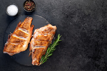 grilled red sea bass with rosemary and spices on a stone background  with copy space for your text