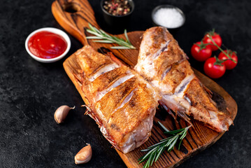 grilled red sea bass with rosemary and spices on a stone background 