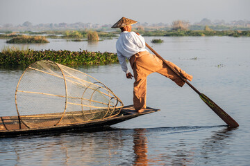 Intha fisherman leg rowing in traditional style on Inle Lake, Shan State, Myanmar (Burma).