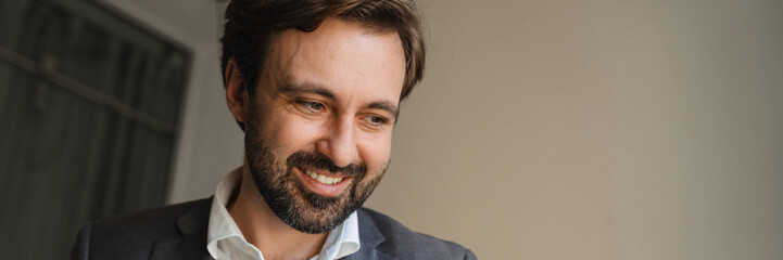 Obraz premium Smiling mid aged businessman looking at laptop