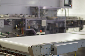 Line for the production of chocolate in an industrial factory. Automatic process in the production line of sweets. Images from the chocolate factory during production. Conveyor belt with sweets.