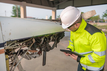 Technician fixing the engine of the airplane,Female aerospace engineering checking aircraft engines,Asian mechanic maintenance inspects plane engine