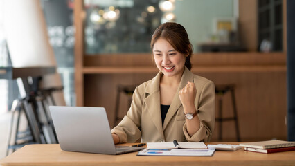 Successful young Asian businesswoman at work that achieve their goals.