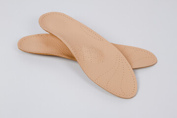 Isolated orthopedic insoles on a white background. Medical insoles. Foot care. Insole cutaway layers. Treatment and prevention of flat feet and foot diseases. Inner soles of shoes