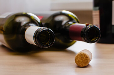 Two empty bottles of wine and a cork lie randomly on the table. The concept of the problem of...