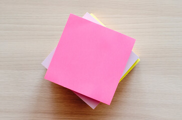 A stack of colored stickers on a neutral background. Place for text, copyspace. View from above.