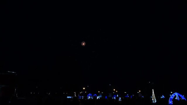 Volleys of festive night fireworks in black sky