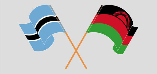 Crossed and waving flags of Botswana and Malawi