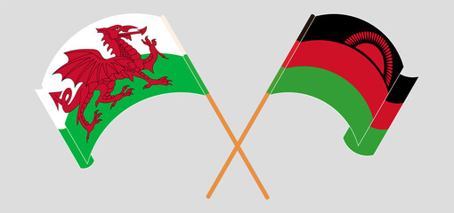 Crossed and waving flags of Wales and Malawi