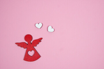 angel with two hearts on a pink background