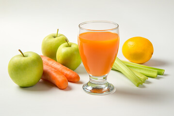 Apple carrot and celery juice on a white background with ingredients. Selected focus. - 487176086