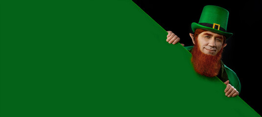 Leprechaun elf on St. Patrick's Day. Cheerful character Irish leprechaun for advertising with a red...