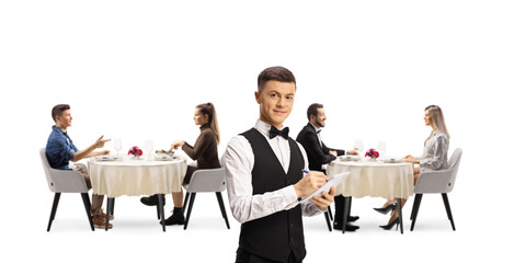 Young waiter in a restaurant and people dining in the back
