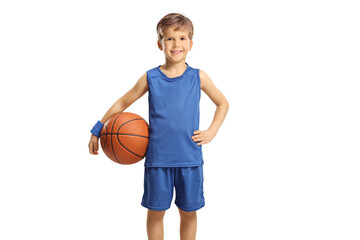 Boy in a blue jersey holding a basketball and smiling