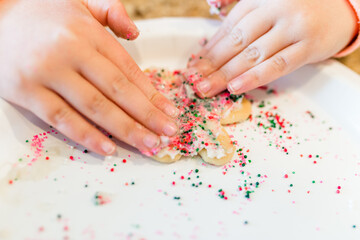 Obraz na płótnie Canvas Child Hands Decorating Christmas Cookie