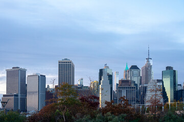 Fototapeta na wymiar Financial district skyline of downtown New York City, Modern buildings over trees
