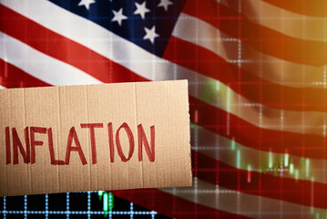 Cardboard with word inflation on background with market exchange rates graph and american flag, Stock markets fall due to inflation