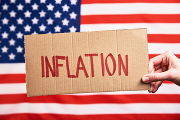 World economic crisis and inflation concept, Woman hold paper sheet with word inflation against...