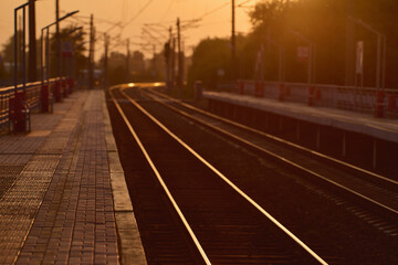 The railtrack go into the distance. Railway station at sunset